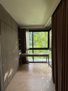 a hallway with a large window and a bench in a room at Cozy room in Sukumvit in Bangkok