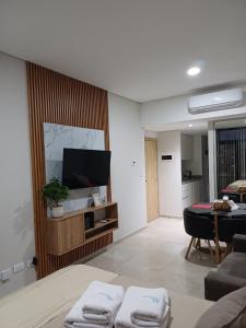 a living room with a flat screen tv on a wall at Bonhomía Bim Tower in Neuquén