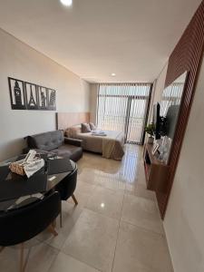 a living room with a couch and a bed at Bonhomía Bim Tower in Neuquén
