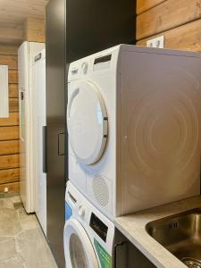 a kitchen with a washing machine and a sink at Mountain Lodge With Views Over Idre in Idre