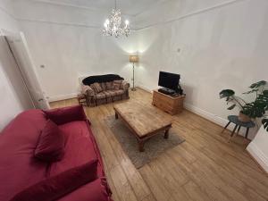 a living room with a couch and a table at Banks Road in West Kirby