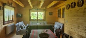a living room with a table and chairs in a cabin at Chata RAIKA in Čierny Potok