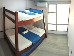 two bunk beds in a room with a window at Villa Liam Casa Turística in Prado