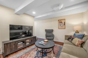a living room with a couch and a tv and a table at Near Downtown & Waterfront, AC, Pet Friendly in Tacoma