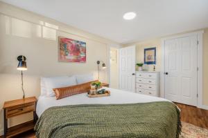 a bedroom with a large white bed and a dresser at Near Downtown & Waterfront, AC, Pet Friendly in Tacoma