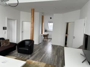 a living room with a couch and a chair at Ferienwohnung Steinberg in Dietzenbach