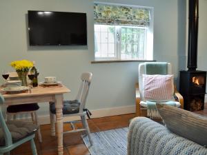 a living room with a table and a fireplace at The Blue Loft in Rye