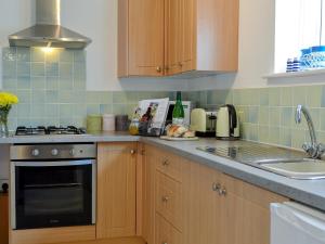 a kitchen with a sink and a stove top oven at The Blue Loft in Rye