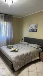 a bedroom with a large bed with towels on it at Appartamento Ely in Pioltello