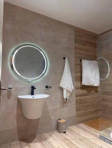 a bathroom with a sink and a mirror at Studio meublé à PNR in Pointe-Noire