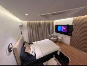 a hospital room with a bed and a tv at Studio meublé à PNR in Pointe-Noire