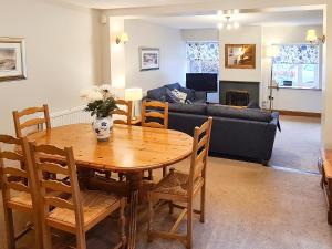a living room with a table and a couch at Joan's Cottage in Braithwaite