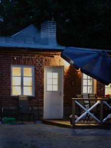 a brick house with a blue umbrella in front of it at Villa Linnea in Hanko