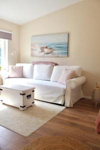 a living room with a white couch and a table at Villa Linnea in Hanko