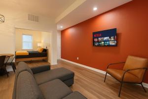a living room with a couch and a bed at Soulard King Loft near Anheuser-Busch Brewery in Soulard