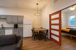 a small apartment with a table and a bed at Soulard King Loft near Anheuser-Busch Brewery in Soulard +8 photos