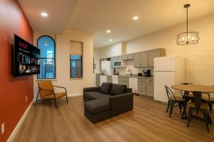 a living room with a couch and a table at Soulard King Loft near Anheuser-Busch Brewery in Soulard