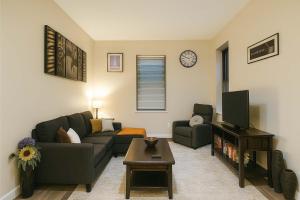 ein Wohnzimmer mit Sofa und Fernseher in der Unterkunft Bright Soulard Loft-King-Queen 2 Baths Parking in Soulard + 9 Fotos