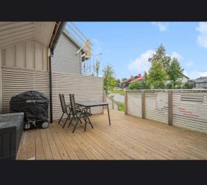 a patio with a table and chairs on a deck at Apartment in central Kirkenes in Kirkenes +3 photos