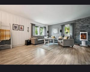 a living room with couches and a fireplace at Apartment in central Kirkenes in Kirkenes