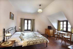 um quarto com uma cama, uma mesa e cadeiras em Penzion Na 15. Poledníku em Jindřichŭv Hradec
