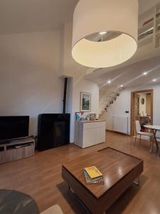 a living room with a coffee table and a large light fixture at Casa los Rebecos in Villanúa