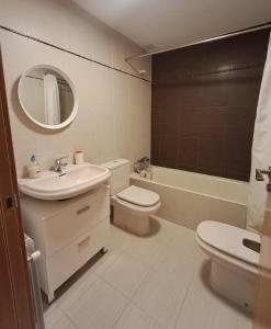 a bathroom with a sink toilet and a mirror at Casa los Rebecos in Villanúa +4 photos