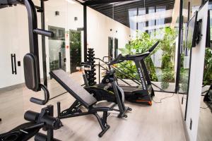 a gym with treadmills and exercise bikes in a room at Coroados Hotel & Flats in Nova Prata