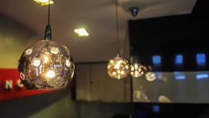 two lights hanging from the ceiling in a room at The Studio 18 Residences in Manila
