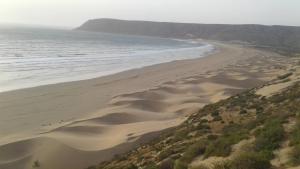 an aerial view of a beach with sand and the ocean at Chezidar Tafadna Essaouira 