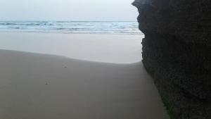 a view of a beach with the ocean in the background at Chezidar Tafadna Essaouira  +8 photos