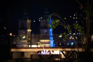 a fountain in front of a building at night at A beautiful apartment in the center in Valle de Bravo +2 photos
