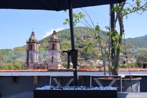 a table with an umbrella and a view of a city at A beautiful apartment in the center in Valle de Bravo