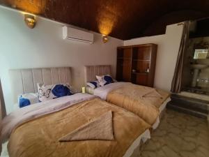 a bedroom with two beds in a room at Go Inn Backpackers in Aswan