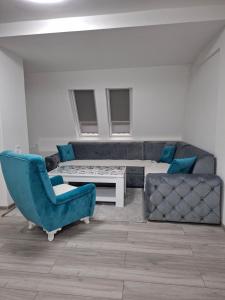 a living room with a couch and a table and chairs at Stan na dan Vlasenica in Vlasenica