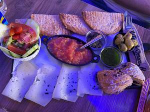 a plate of food with dip and bread and dips at Studio sky lux 94 in Tangier +4 photos