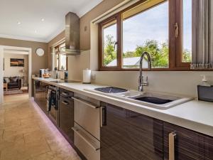a kitchen with a sink and a window at Rivendell Lodge - Cottage in East Winch +33 photos