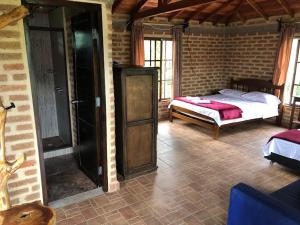 a bedroom with a bed in a brick room at Finca la Albania in Circasia