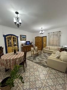 a living room with a table and a couch at Pousada Sinhá Moça Campos Ltda in São João del Rei