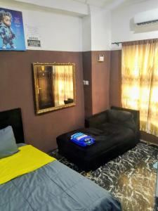 a room with a bed and a couch and a chair at Short Let Apartments in Lagos Business School Lekki Ajah in Lekki +17 photos