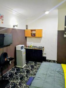 a room with a kitchen with a sink and a refrigerator at Short Let Apartments in Lagos Business School Lekki Ajah in Lekki