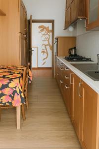 a kitchen with a table and a dining room at DesireeHoliday in Le Grazie