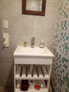 a white sink in a bathroom with a mirror at Casa Tiale - Chapadmalal , Campo y Olas- in Colonia Chapadmalal
