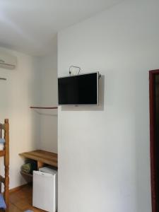 a refrigerator with a television on top of it at Pousada Estrada Real in Paraty
