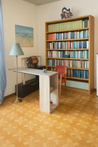 a room with a desk and a book shelf at DesireeHoliday in Le Grazie +14 photos