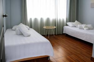 Postel nebo postele na pokoji v ubytování Hostal Wayare Filandia