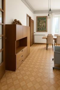 a living room with a large cabinet and a table at DesireeHoliday in Le Grazie