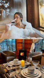 a woman sitting in a bath tub drinking a glass of wine at Cabana Alpen Ville com Banheira - Rural - 01 in Bom Jardim da Serra