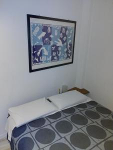 une chambre avec un lit avec un tableau sur le mur dans l'établissement Sondrio civico 12, à Sondrio 3 autres photos