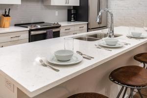 a kitchen counter with two cups and plates on it at The Saddlery-Frequency-2 Units-Walk 2 Broadway in Nashville +68 photos